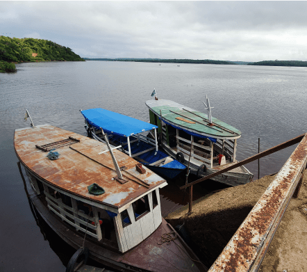 Three boats moored at a riverbank
